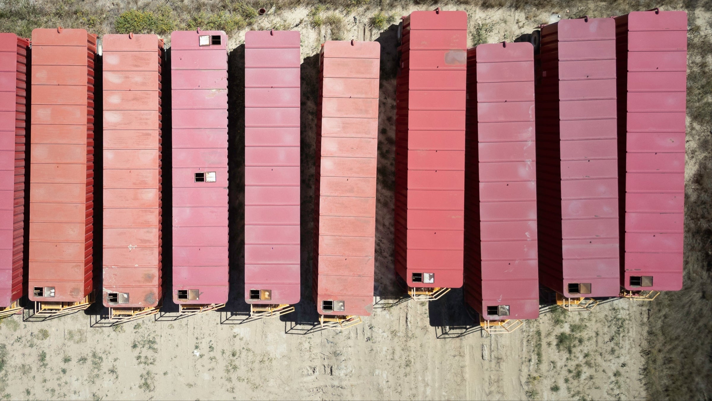 Birds eye view of a row of red 21,000 gallon frac tanks