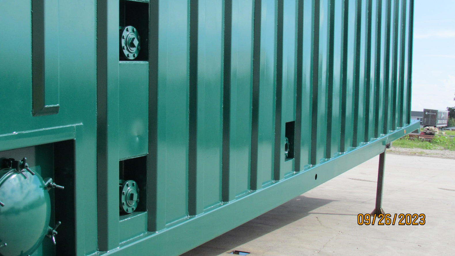 A sideview of a freshly painted 21,000 gallon weir frac tank