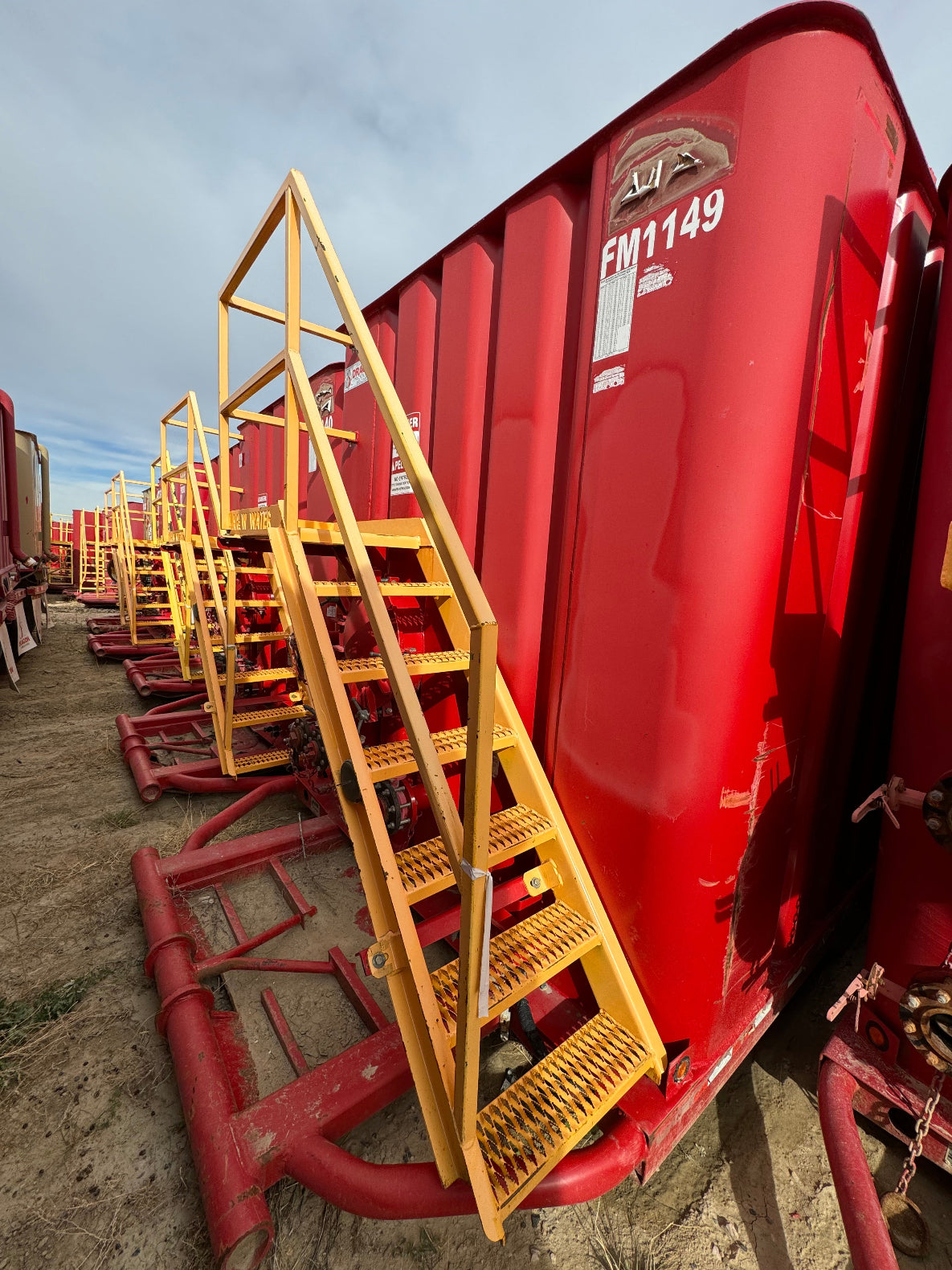 A row of red Dragon used frac tanks